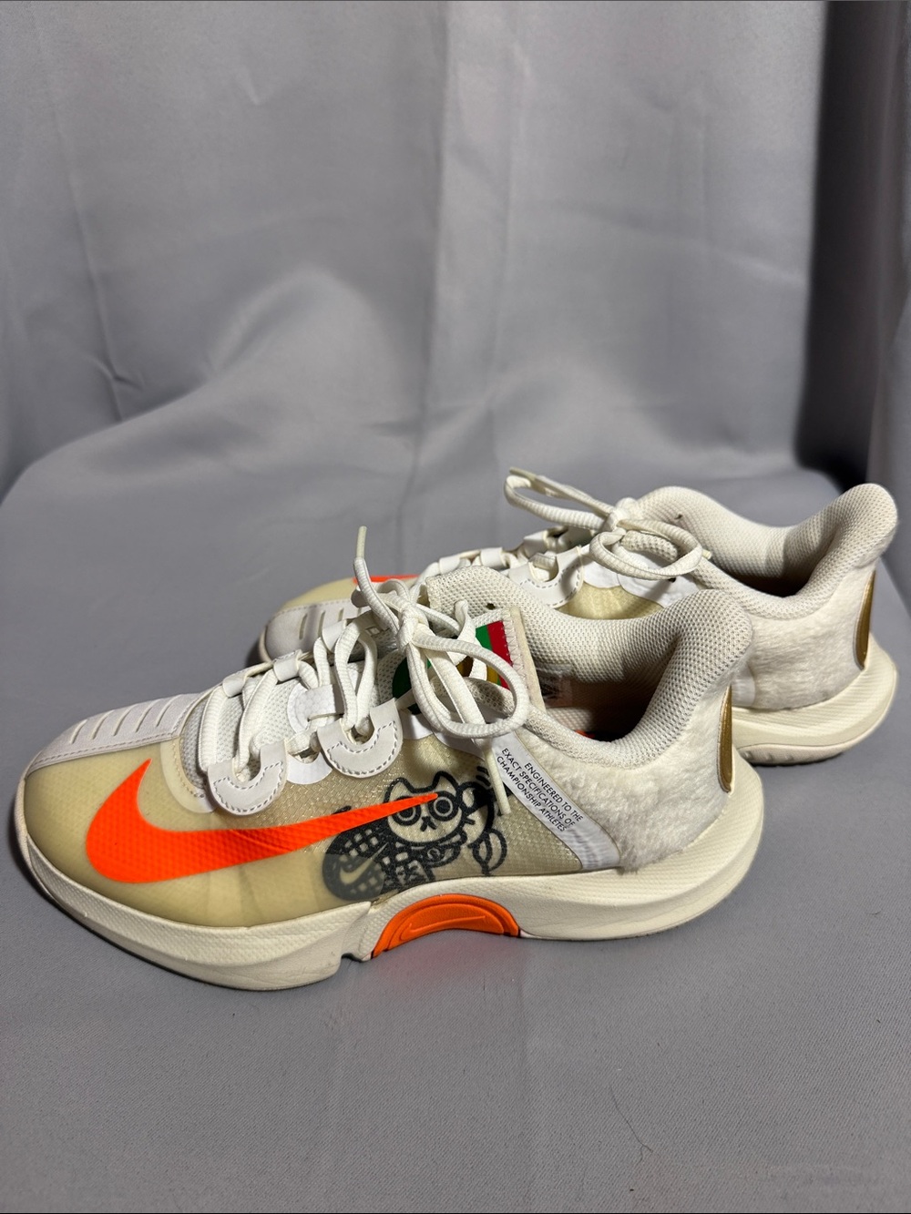 Nike Kids White Sneakers with Bright Orange Swoosh and Graphic